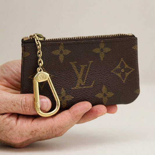 Hand holding the Louis Vuitton Pochette Clés key pouch