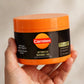 Hand holding the Carroten Intensive Tanning Gel jar