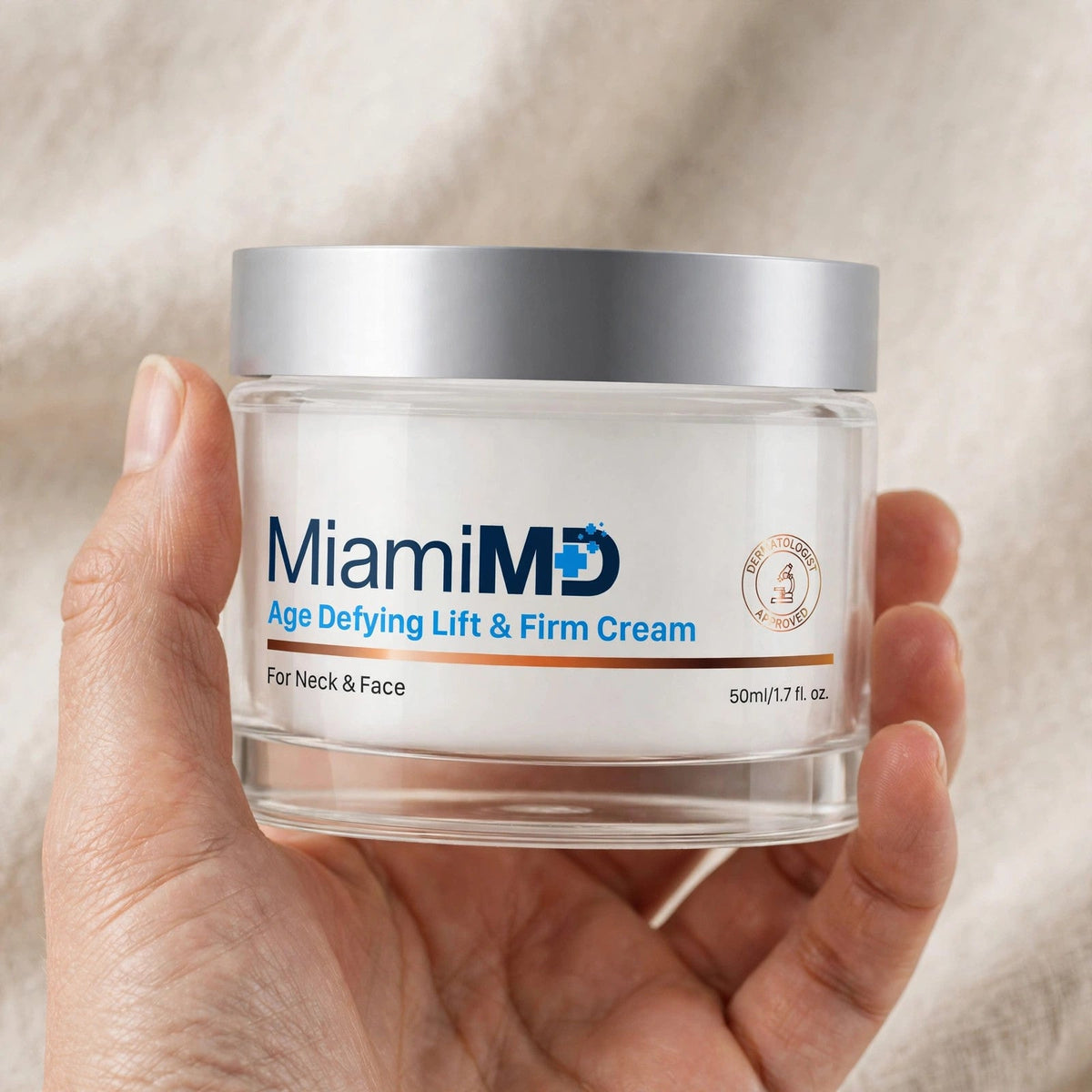 Hand holding the MiamiMD Age Defying Lift and Firm Cream jar