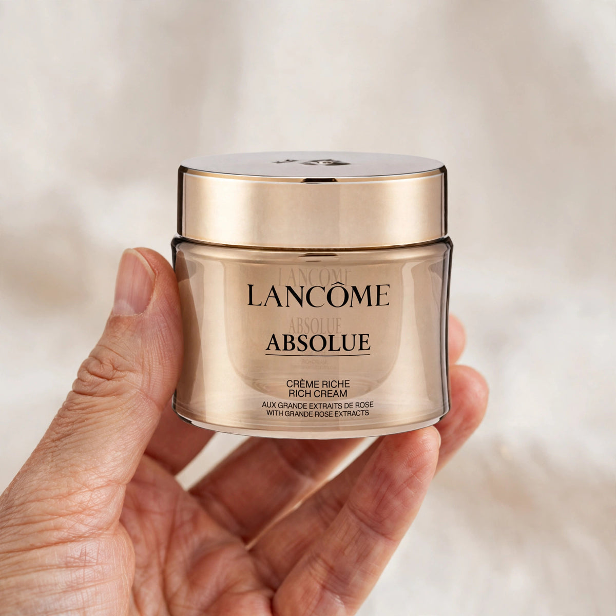 Lancôme Absolue Rich Cream jar held in hand