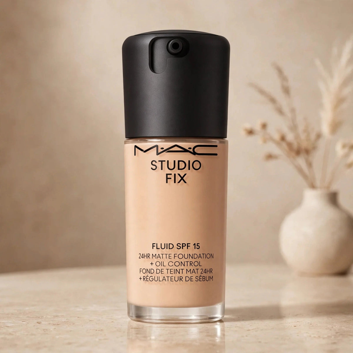 MAC Studio Fix Fluid SPF 15 foundation NC27 in warm beige studio setting