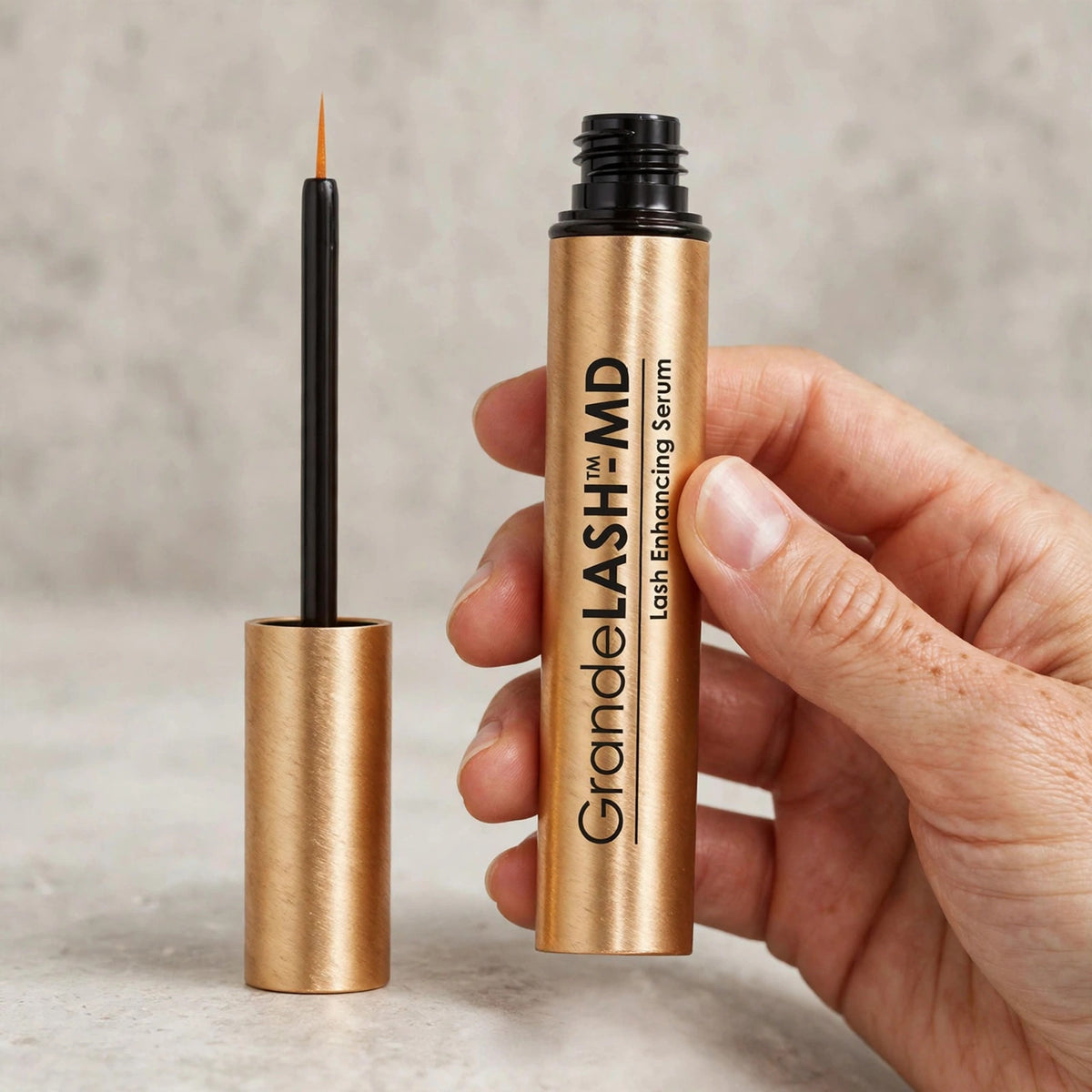 GrandeLASH-MD Lash Enhancing Serum held in hand