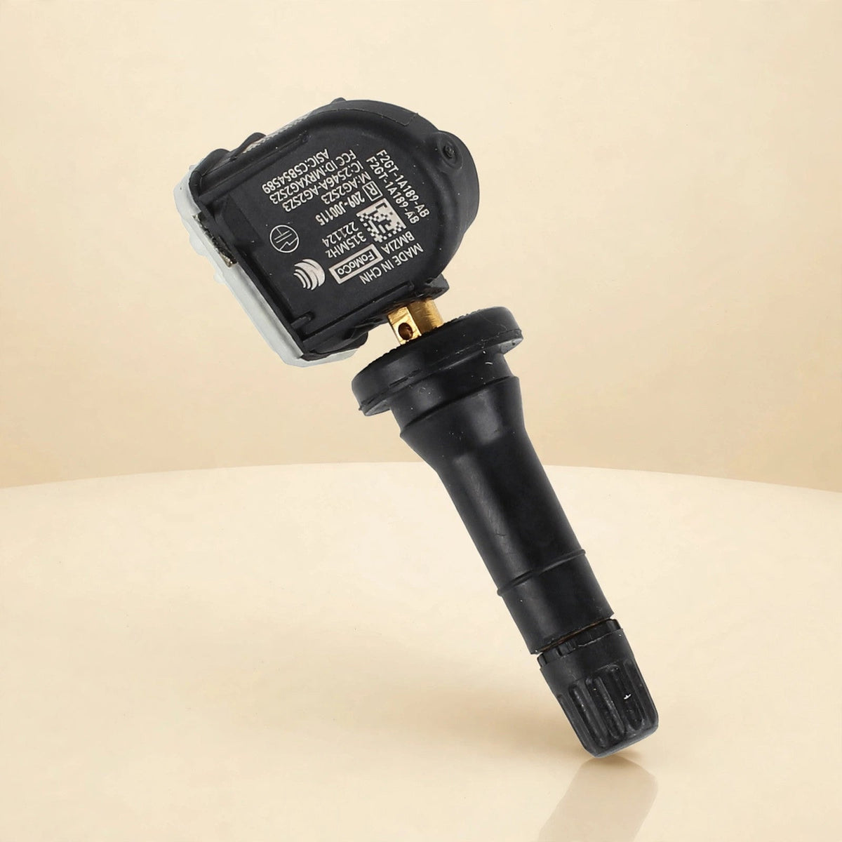 Ford F2GZ-1A189-AB TPMS tire pressure sensor in a cream studio