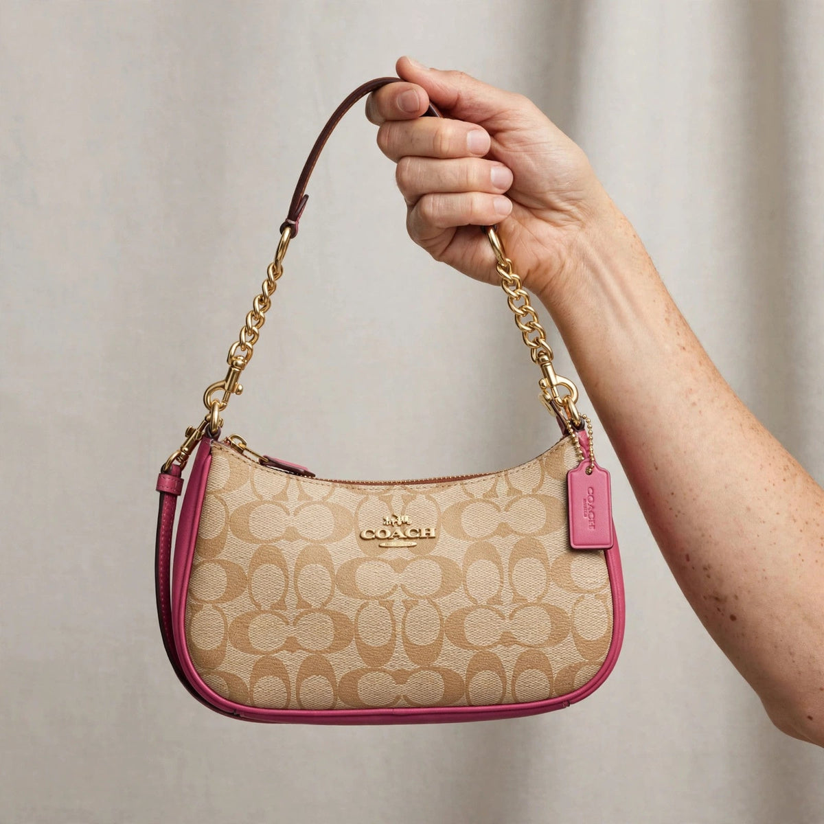 Coach Teri Shoulder Bag in signature canvas held in hand