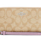 Coach zip-around long wallet in signature canvas with purple strap, detail view