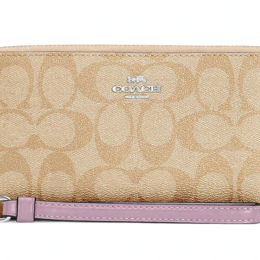 Coach zip-around long wallet in signature canvas with purple strap, detail view