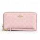 Coach CW778 long zip-around wallet in powder pink signature canvas on white background