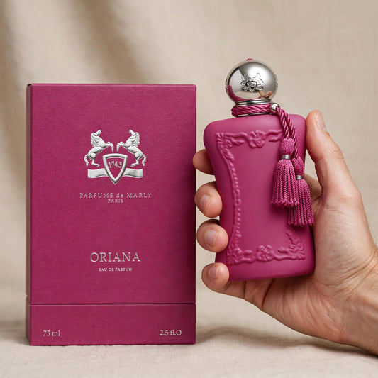 Hand holding Parfums de Marly Oriana perfume bottle