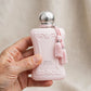 Hand holding Parfums de Marly Delina Exclusif perfume bottle