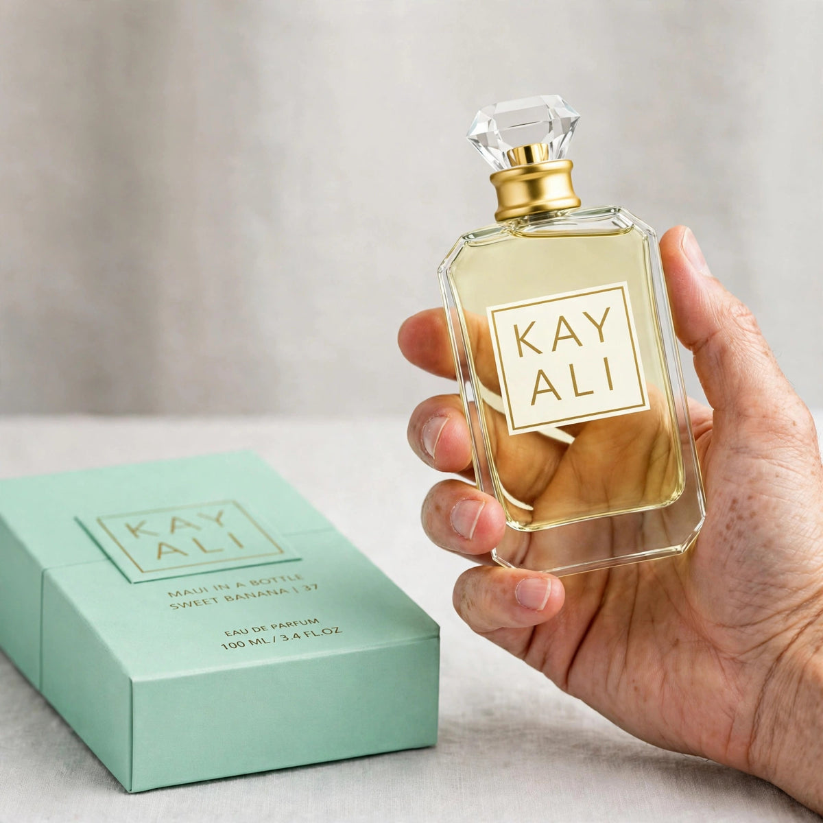 Kayali Maui In A Bottle Sweet Banana 37 Eau de Parfum 100ml / 3.4oz for Women — hand shot