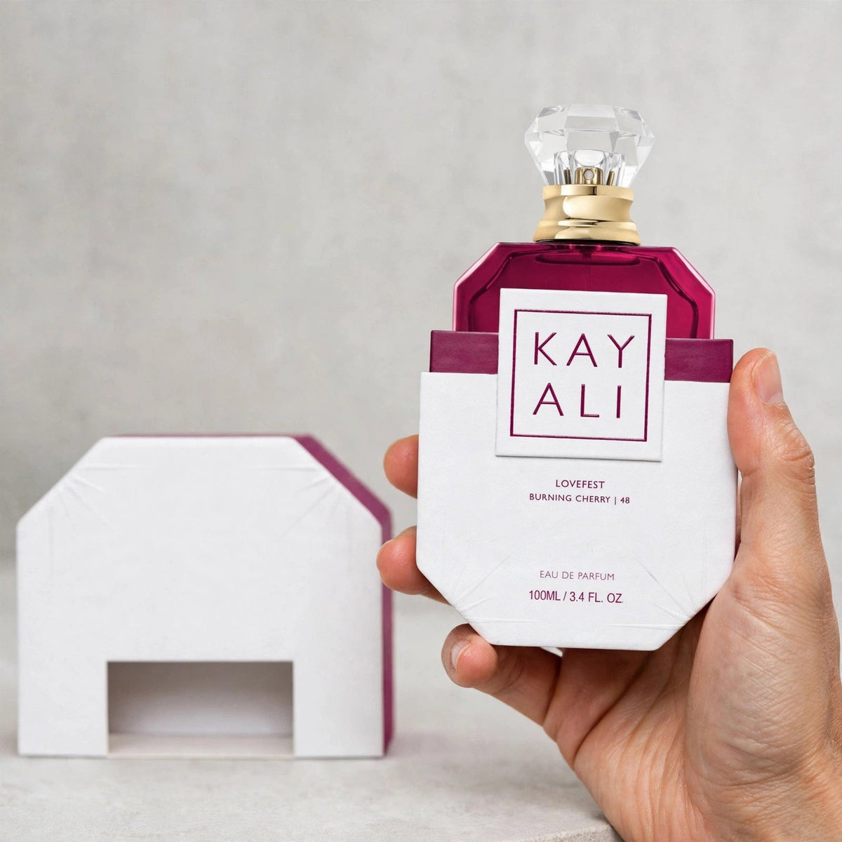 Kayali Lovefest Burning Cherry 48 Eau de Parfum 100ml / 3.4oz for Women — hand view