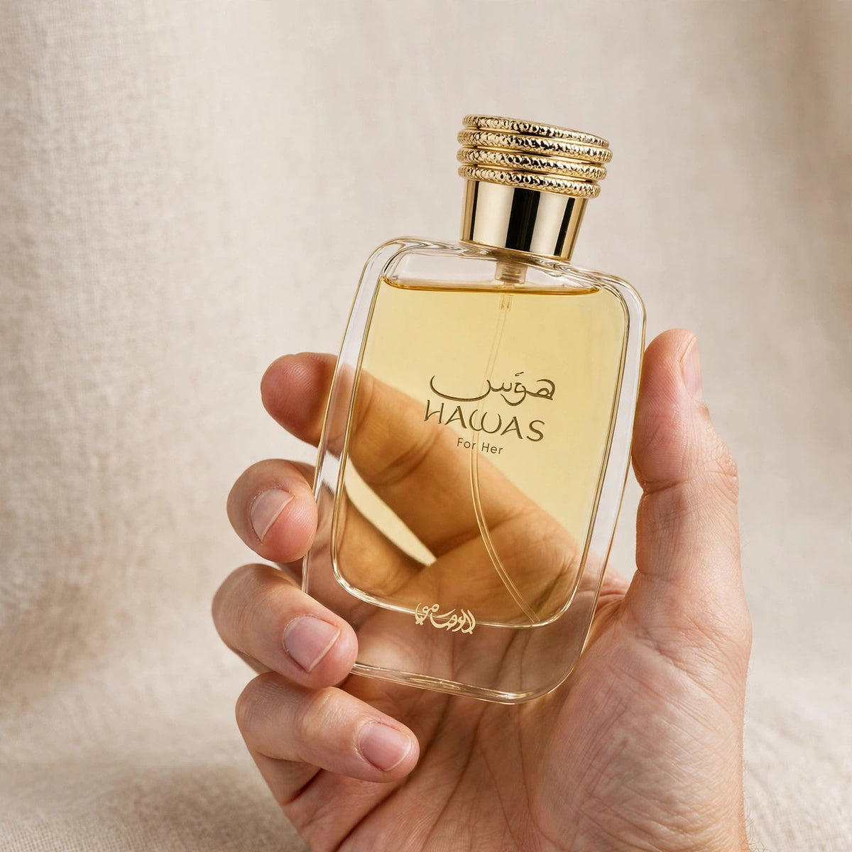 Hand holding Rasasi Hawas for Her EDP perfume bottle