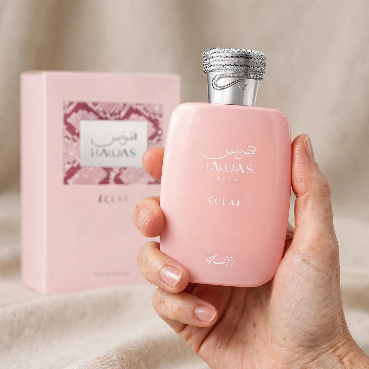 Hand holding Rasasi Hawas Eclat for Her EDP perfume bottle