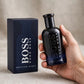 Hand holding Hugo Boss Bottled Night EDT perfume bottle