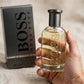 Hand holding Hugo Boss Bottled EDT perfume bottle