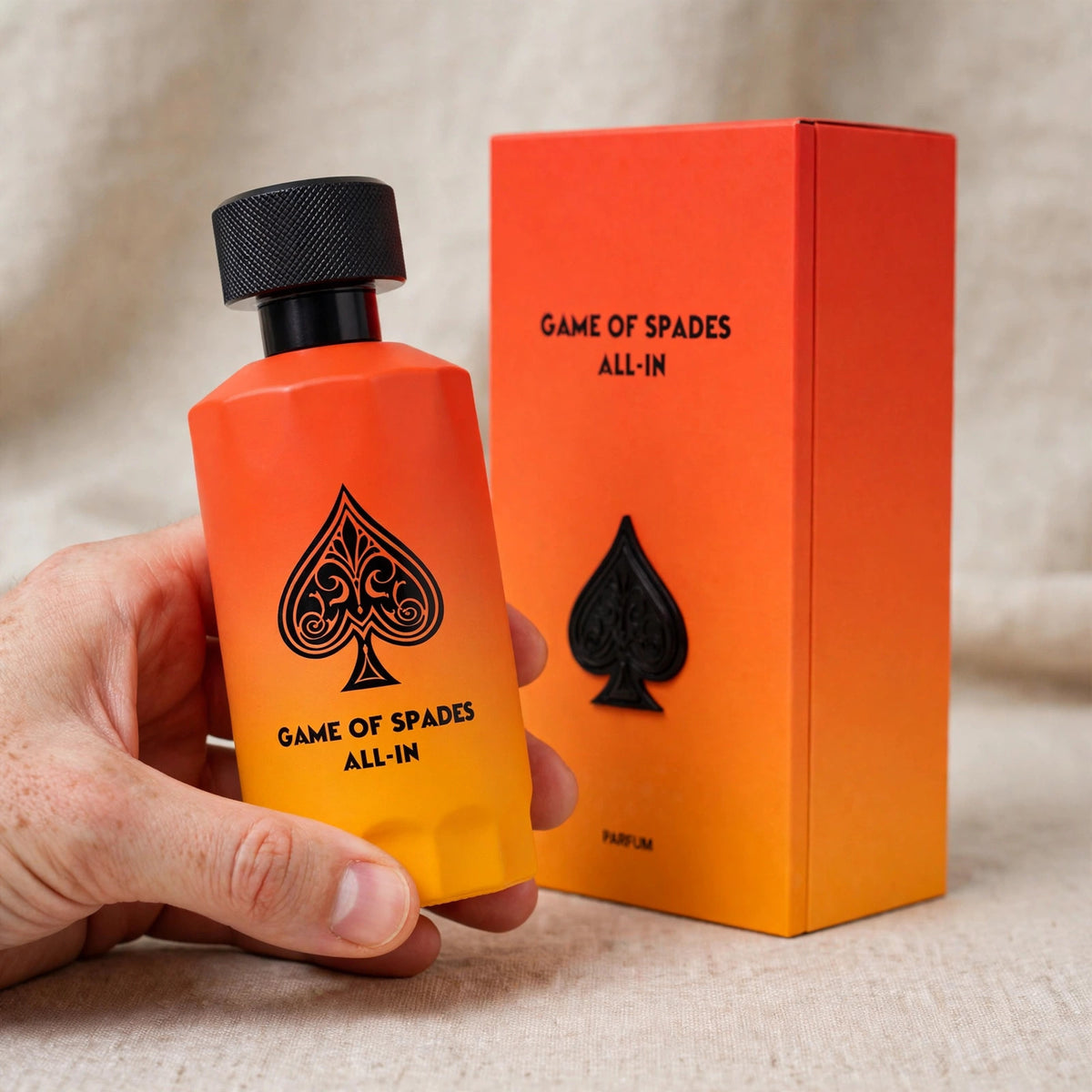 Hand holding Jo Milano Game of Spades All-In Parfum 100ml bottle
