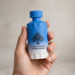 Hand holding Jo Milano Game of Spades Double Bonus Parfum 100ml bottle