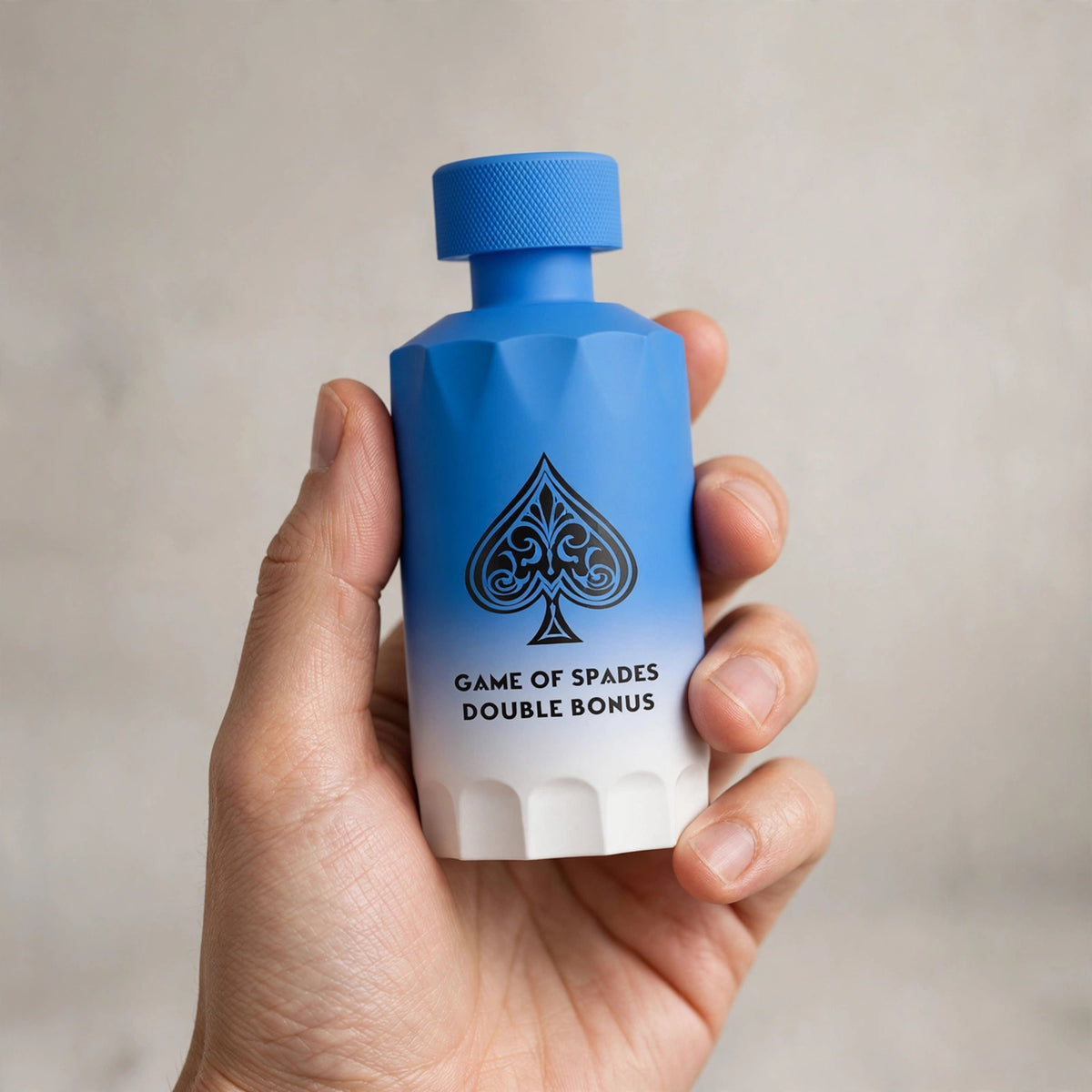 Hand holding Jo Milano Game of Spades Double Bonus Parfum 100ml bottle