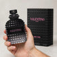 Hand holding Valentino Born In Roma EDT perfume bottle