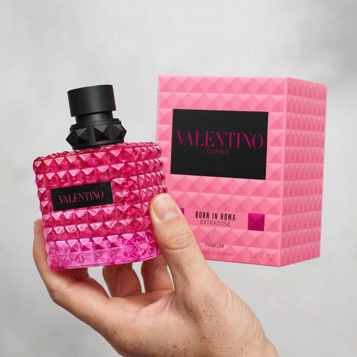 Hand holding Valentino Donna Born In Roma Extradose Parfum perfume bottle