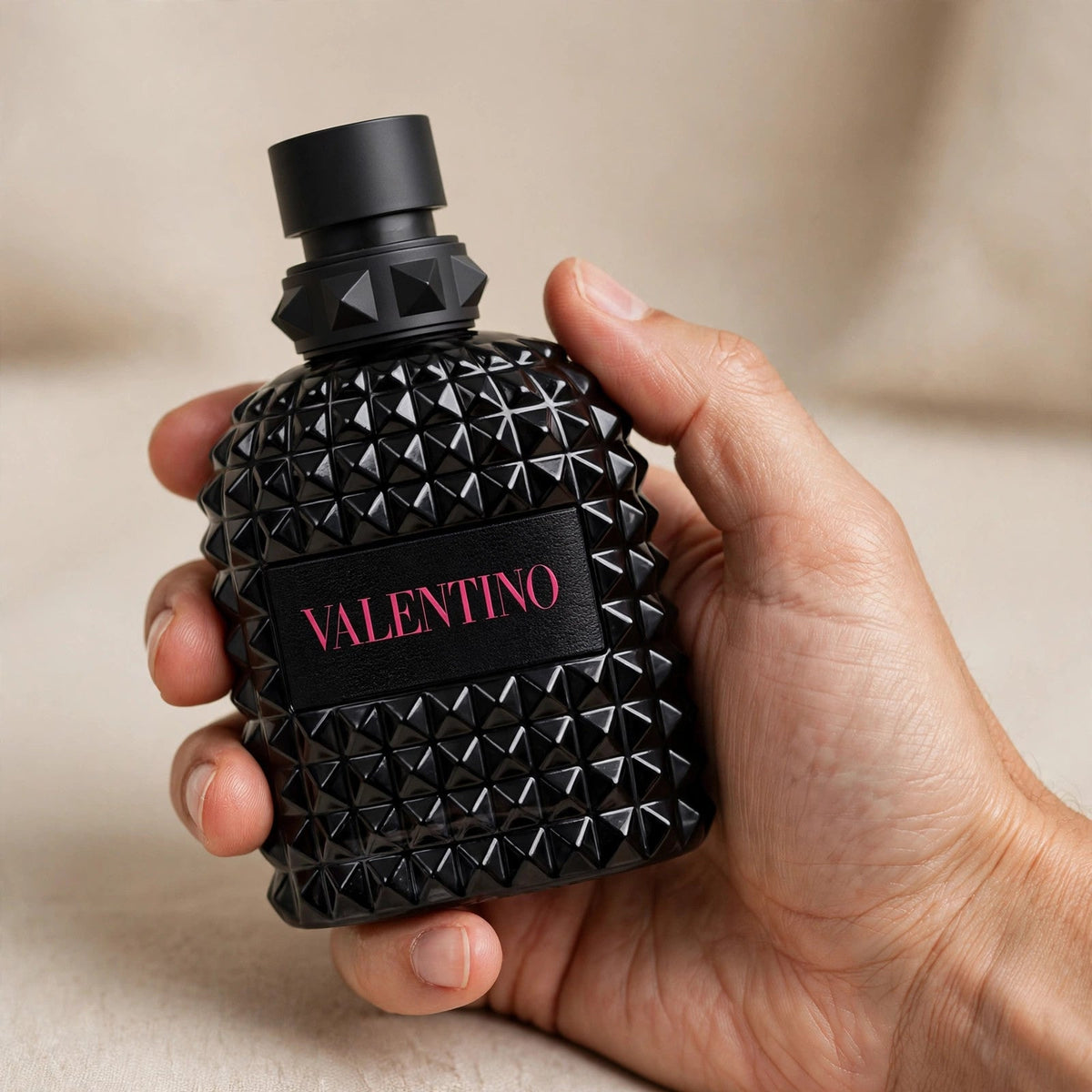 Hand holding Valentino Uomo Born In Roma Extradose Parfum perfume bottle
