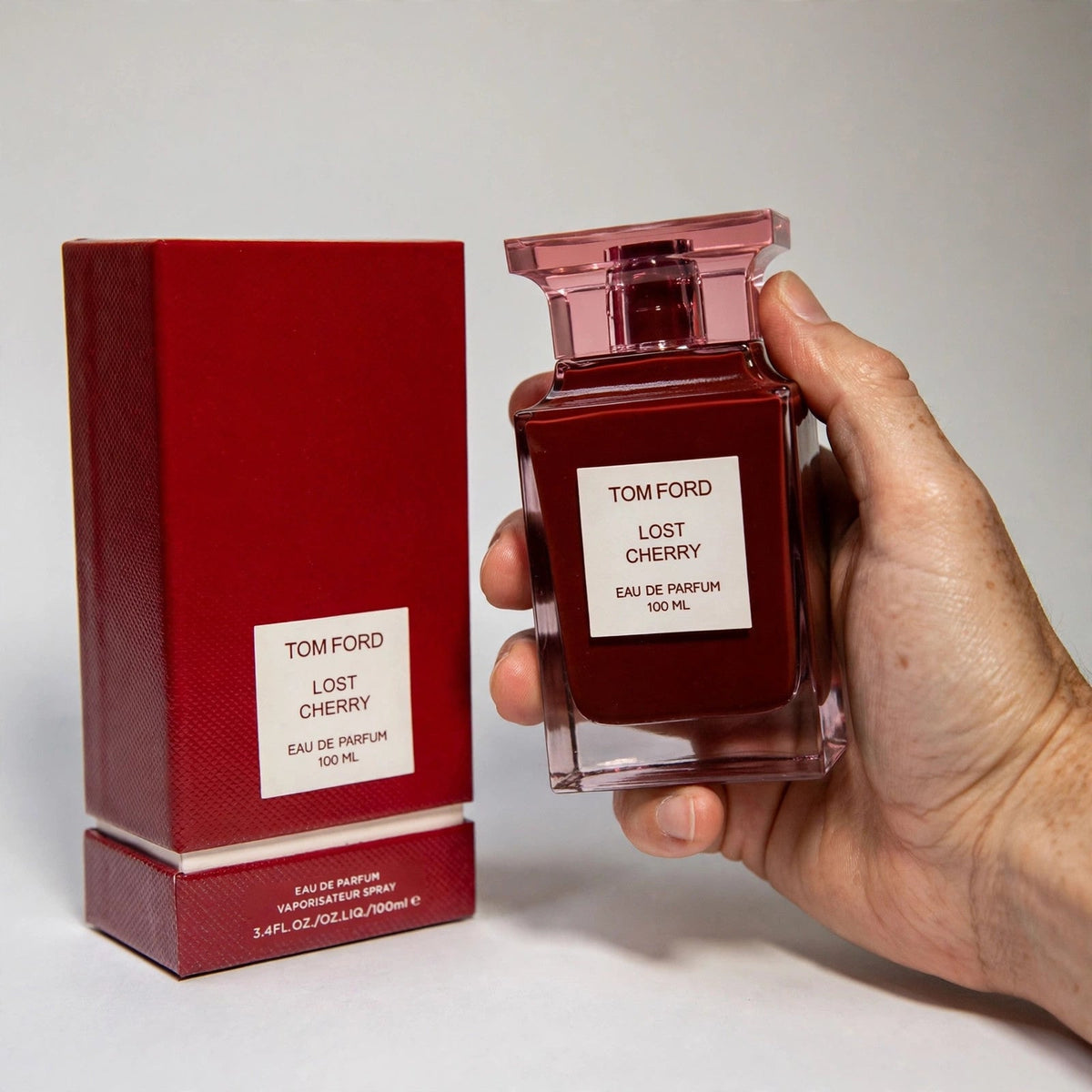 Hand holding Tom Ford Lost Cherry EDP perfume bottle