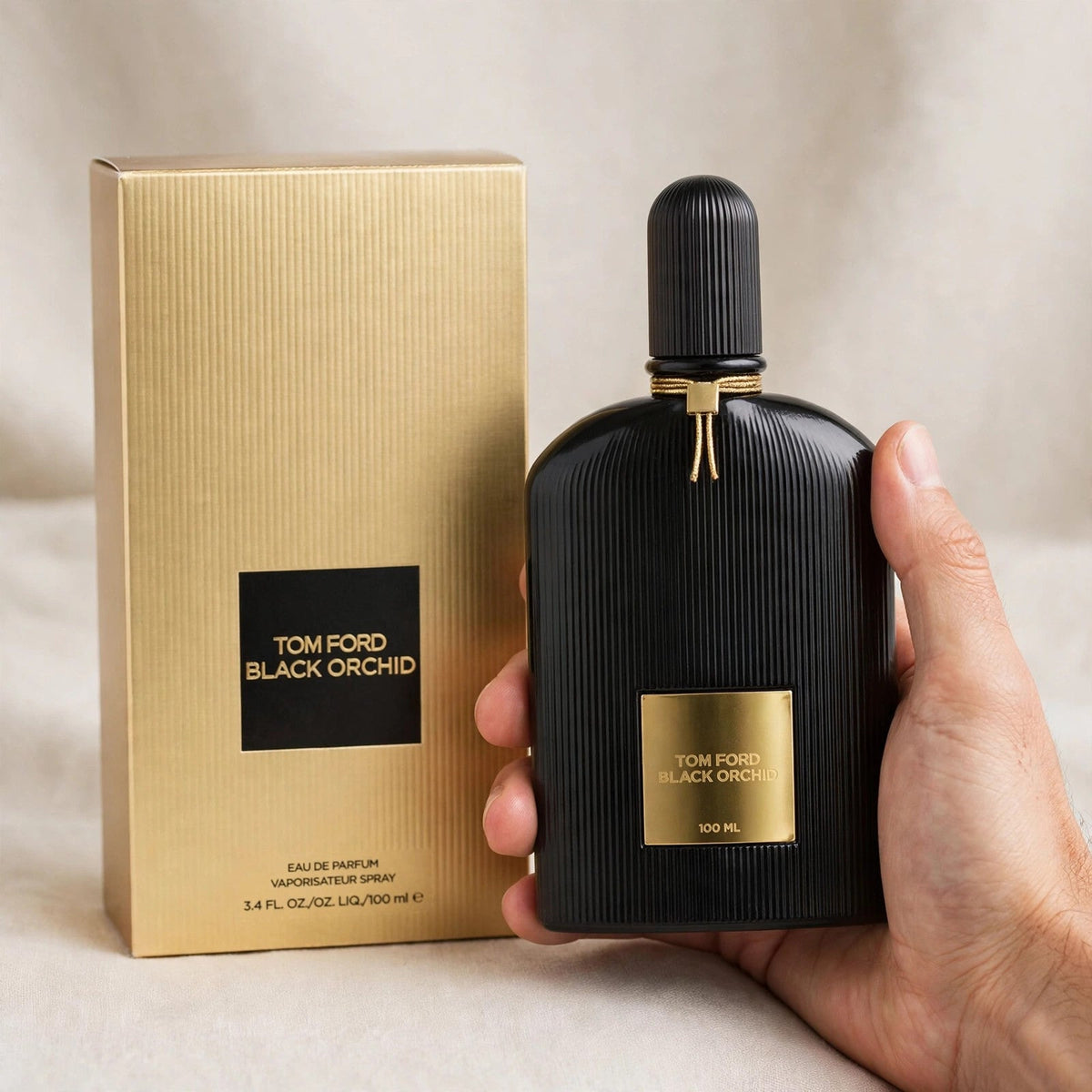 Hand holding Tom Ford Black Orchid EDP perfume bottle