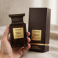 Hand holding Tom Ford Tobacco Vanille EDP perfume bottle