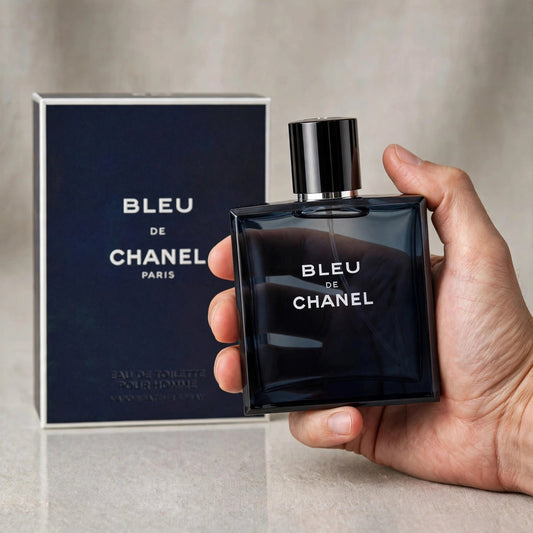 Hand holding Chanel Bleu De Chanel EDT perfume bottle