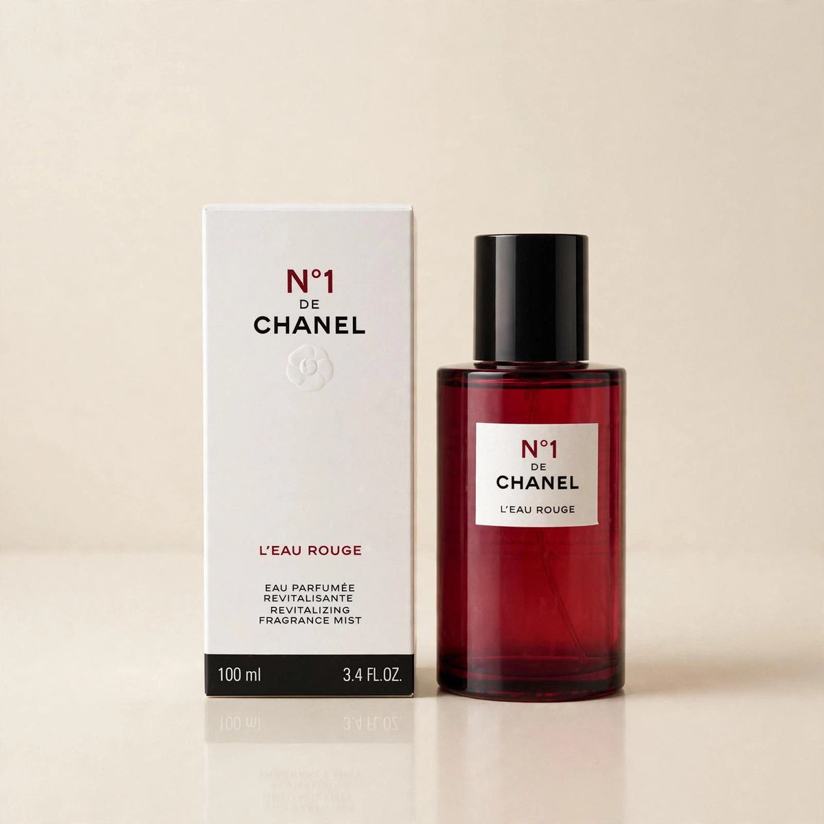 Chanel No 1 L'Eau Rouge mist in a cream studio setting