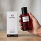 Hand holding Chanel No 1 L'Eau Rouge fragrance mist bottle