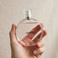 Hand holding Chanel Chance Eau Tendre perfume bottle