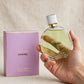 Hand holding Chanel Chance Eau Fraiche EDP perfume bottle