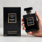 Hand holding Chanel Coco Noir EDP perfume bottle