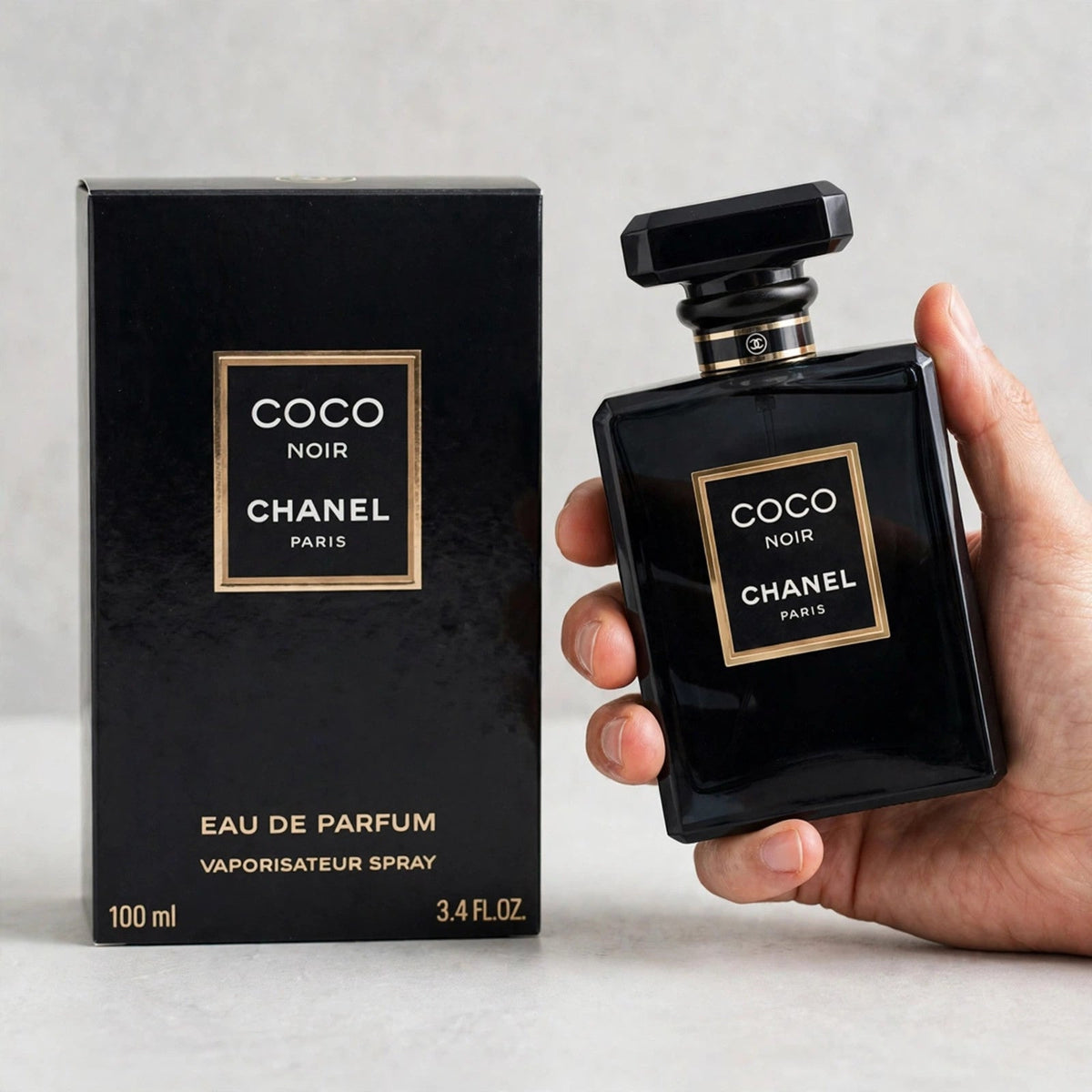 Hand holding Chanel Coco Noir EDP perfume bottle