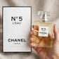 Hand holding Chanel No 5 L'Eau EDT perfume bottle