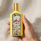 Hand holding Gucci Flora Gorgeous Orchid EDP perfume bottle