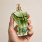 Hand holding Jean Paul Gaultier Le Beau Paradise Garden EDP perfume bottle