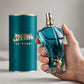 Hand holding Jean Paul Gaultier Le Beau EDT perfume bottle