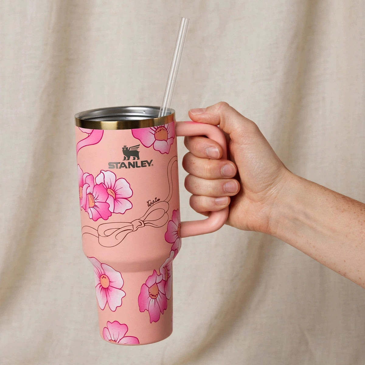 Hand holding the Barbie x Just Peachy 40oz tumbler