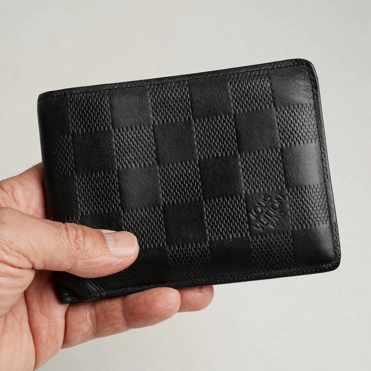 Louis Vuitton Multiple Bifold Wallet – Damier Graphite Black — hand product photo