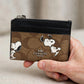 Coach x Peanuts Mini Skinny ID Case – Signature Canvas Snoopy Print — hand product photo