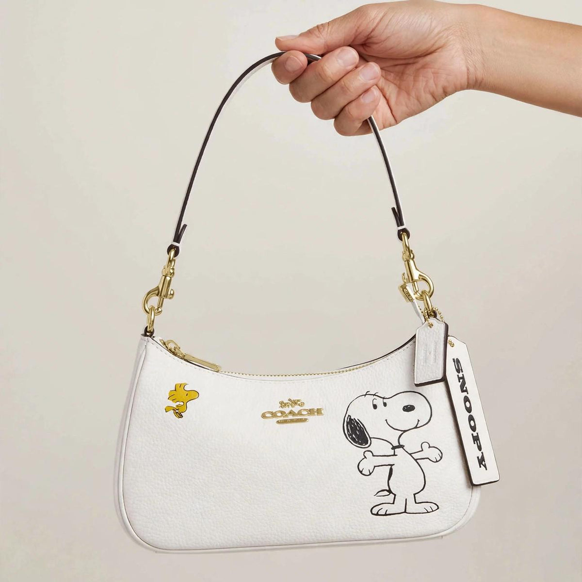 Coach x Peanuts Teri Shoulder Bag – Snoopy White Leather — hand product photo