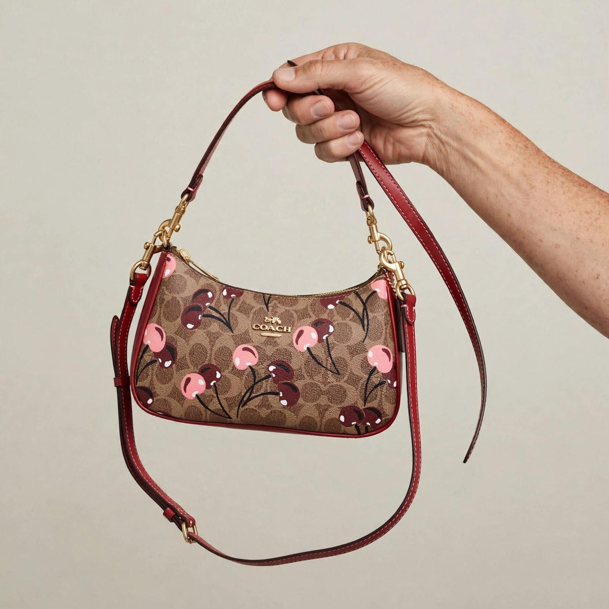 Coach Teri Shoulder Bag – Signature Canvas Cherry Print — hand product photo
