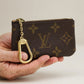 Hand holding the Louis Vuitton Pochette Clés key pouch