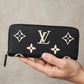 Hand holding the Louis Vuitton Portefeuille Clémence wallet