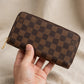 Hand holding the Louis Vuitton Zippy Damier wallet