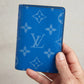 Hand holding the Louis Vuitton Surfin’ Blue pocket organizer