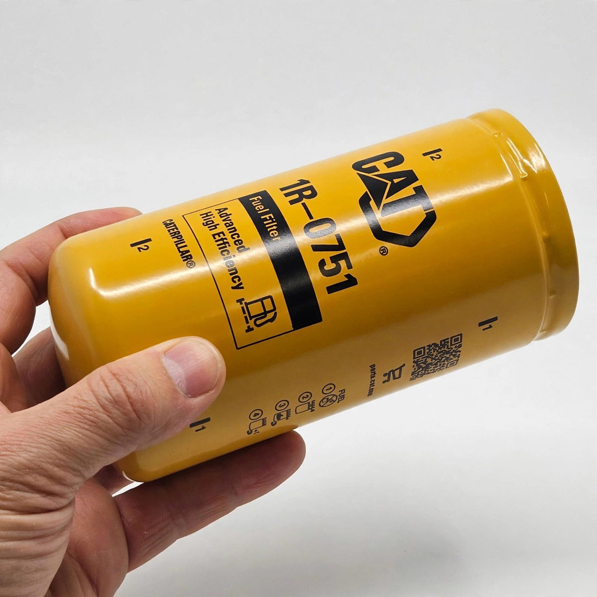 Hand holding the Caterpillar 1R-0751 fuel filter
