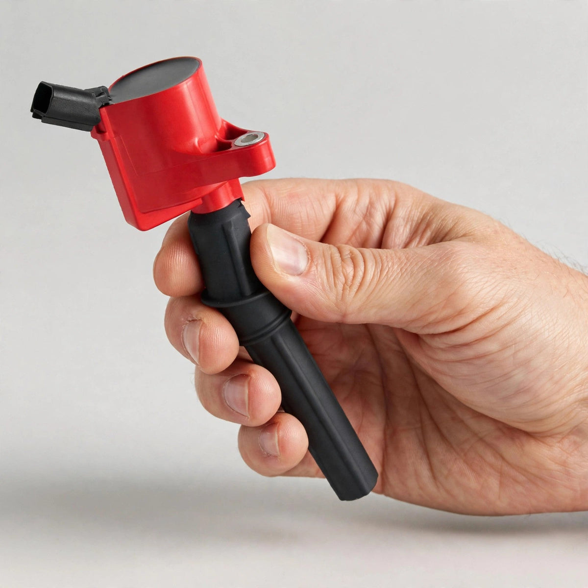 Hand holding a DG508 ignition coil